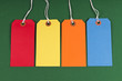 4 Coloured Luggage tags on green background