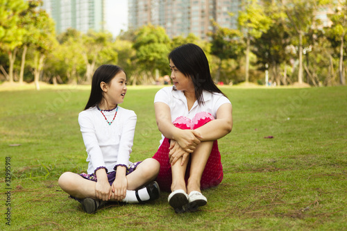 Photo: asian mother and daughter having a conversation asian mother and daughter having a conversation
