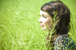 Portrait of pretty young woman in the grass in the field