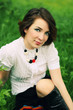 Portrait of pretty young woman in the grass in the field