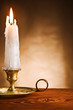Photo: copy space ablaze candle in old candlestick copy space ablaze candle in old candlestick