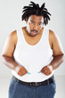 overweight african american man measuring waist