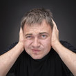 Foto: Confused young man in black T-shirt. Confused young man in black T-shirt.