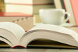 Composition with books and cup of coffee on the table Composition with books and cup of coffee on the table