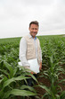 Agronomist analysing cereals with laptop computer