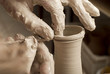 hands of a potter, creating an earthen jar on the circle hands of a potter, creating an earthen jar on the circle
