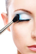 Woman applying blusher eyelid