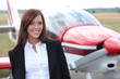 Woman standing in front of a light aircraft