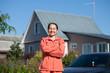 Happy woman against home Happy woman against home