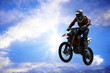 motorcycle jumping from a high rock