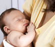Sleeping child in the arms of Mom