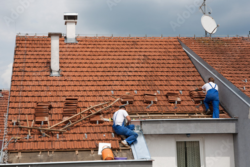 Photo: Two men working on the roof Two men working on the roof