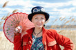 Happy young woman wearing Steampunk clothes in reed