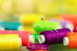 Photo: colorful sewing thread reels, pins and buttons colorful sewing thread reels, pins and buttons
