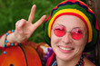 Young hippy woman making peace sign