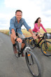 Couple riding bicycle on country road