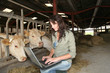 Veterinarian in barn with laptop computer Veterinarian in barn with laptop computer