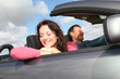 Couple riding convertible car