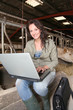 Veterinarian in barn with laptop computer Veterinarian in barn with laptop computer