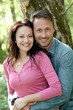 Portrait of smiling couple in forest
