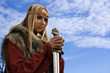 Viking girl on a blue sky background