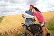 Couple riding looking at map on bike ride