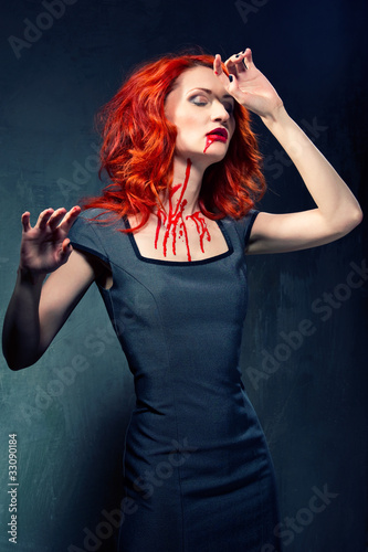 Photo: Portrait of a redhead woman with blood in her face and neck Portrait of a redhead woman with blood in her face and neck