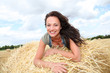 Beautiful woman laying down bale