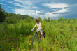 Woman riding bicycle in forest