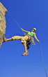 Rock climber rappelling.