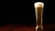 Beer into glass on a black and wooden table Beer into glass on a black and wooden table