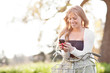 Beautiful woman texting on her phone outdoor