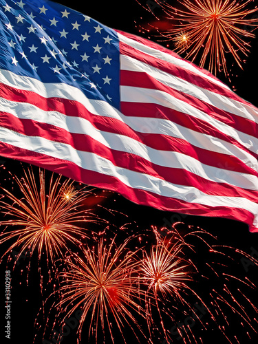 Photo: The American Flag and a Fireworks Display The American Flag and a Fireworks Display