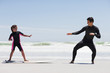 Father teaching daughter to surf