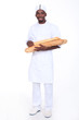 Baker apprentice carrying bread on white background