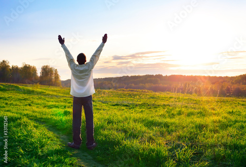 Photo: praying man silhouette on sunset background praying man silhouette on sunset background