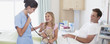 Nurse with father and daughter in hospital