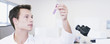 Scientist examining vial in laboratory