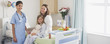 Nurse in children?s hospital with girl patient and mother