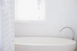 Bathtub under window