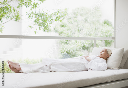 Photo: Woman laying in window Woman laying in window