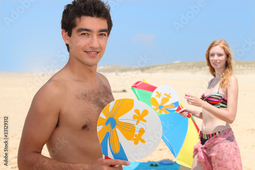 Photo: teenagers playing beach tennis teenagers playing beach tennis