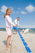 Tug-of-war - family with dog playing on the beach Tug-of-war - family with dog playing on the beach