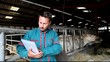Farmer in barn using electronic tablet Farmer in barn using electronic tablet