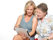 Photo: Old mother and daughter playing with touchpad Old mother and daughter playing with touchpad