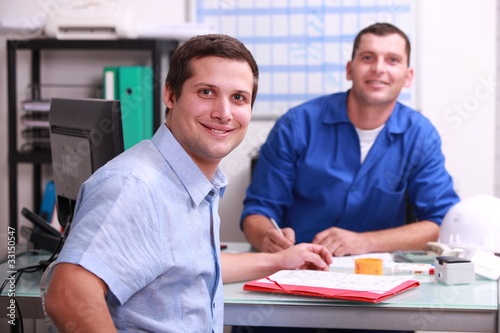Photo: two male colleagues sat in an office two male colleagues sat in an office
