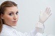 Dentist putting on surgical gloves