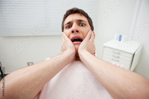 Photo: Patient in dentist's office afraid of treatment Patient in dentist's office afraid of treatment