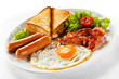 English breakfast - toast, egg, bacon and vegetables English breakfast - toast, egg, bacon and vegetables