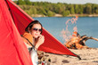 Camping happy woman relax in tent by campfire